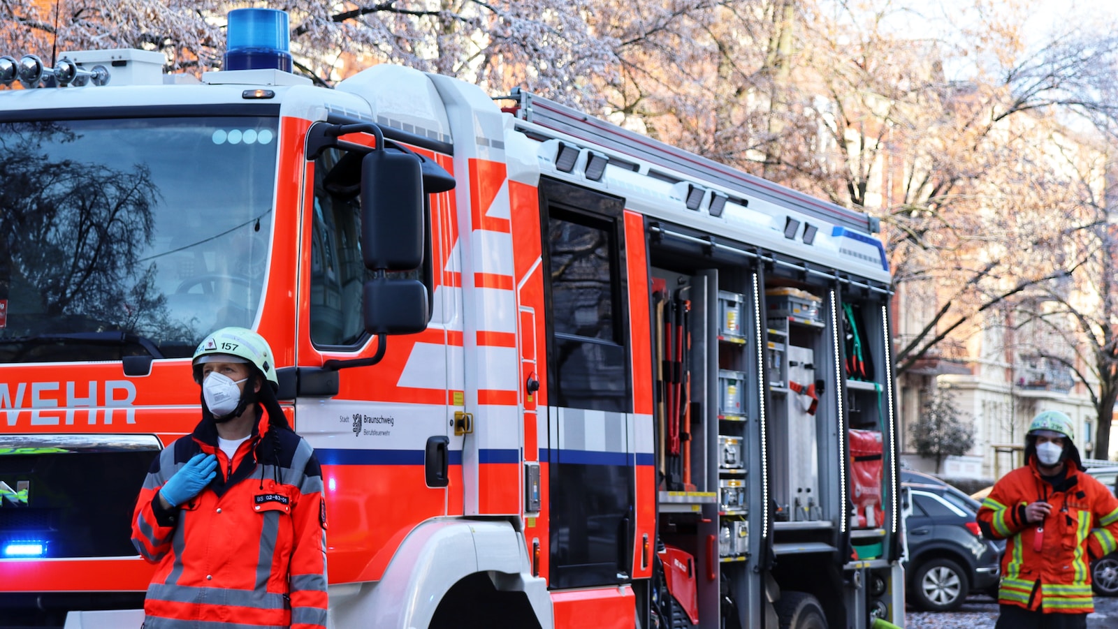 a fireman standing in front of a fire truck